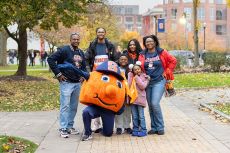 Family standing with Otto on one knee.