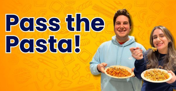 Two students smile and show off their freshly made pasta creations. The food looks delicious! The text on the banner reads, Pass the Pasta!