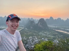 Evan Wichman with a view from the top of Lao Zhaishan overlooking the Li River outside of Xingping in Guangxi Province, China.