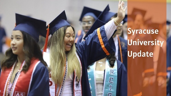 students marching for graduation with one waving her hand