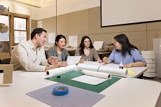 group of students demonstrating an identity-mapping sketching exercise