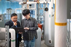 Professor Dong with Ph.D. student Xuezheng Wang working in a laboratory
