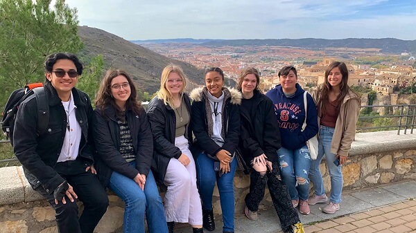 group of Syracuse students sitting with a view of Spain