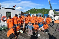 group of crew in Malawi with Syracuse shirts