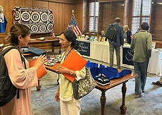 A conference participant speaks with Maxwell alumna Bhavna Davé ’96 Ph.D.