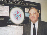 Marvin Goldberg standing in front of a physics research poster