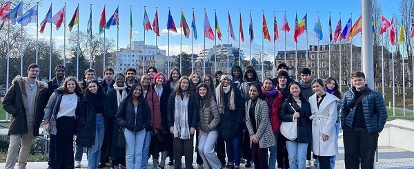 group of students with flags and building on background