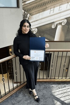 Christy Khoury holding Syracuse diploma