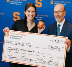 Two individuals holding a check.