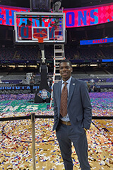 Tobi poses on a basketball court after a game