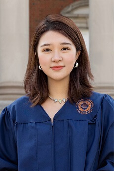 Ava Hu photo wearing Syracuse graduation gown