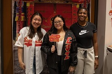 three students pose for chinese new year