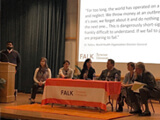 Forum panelists sit on stage in Grant auditorium.